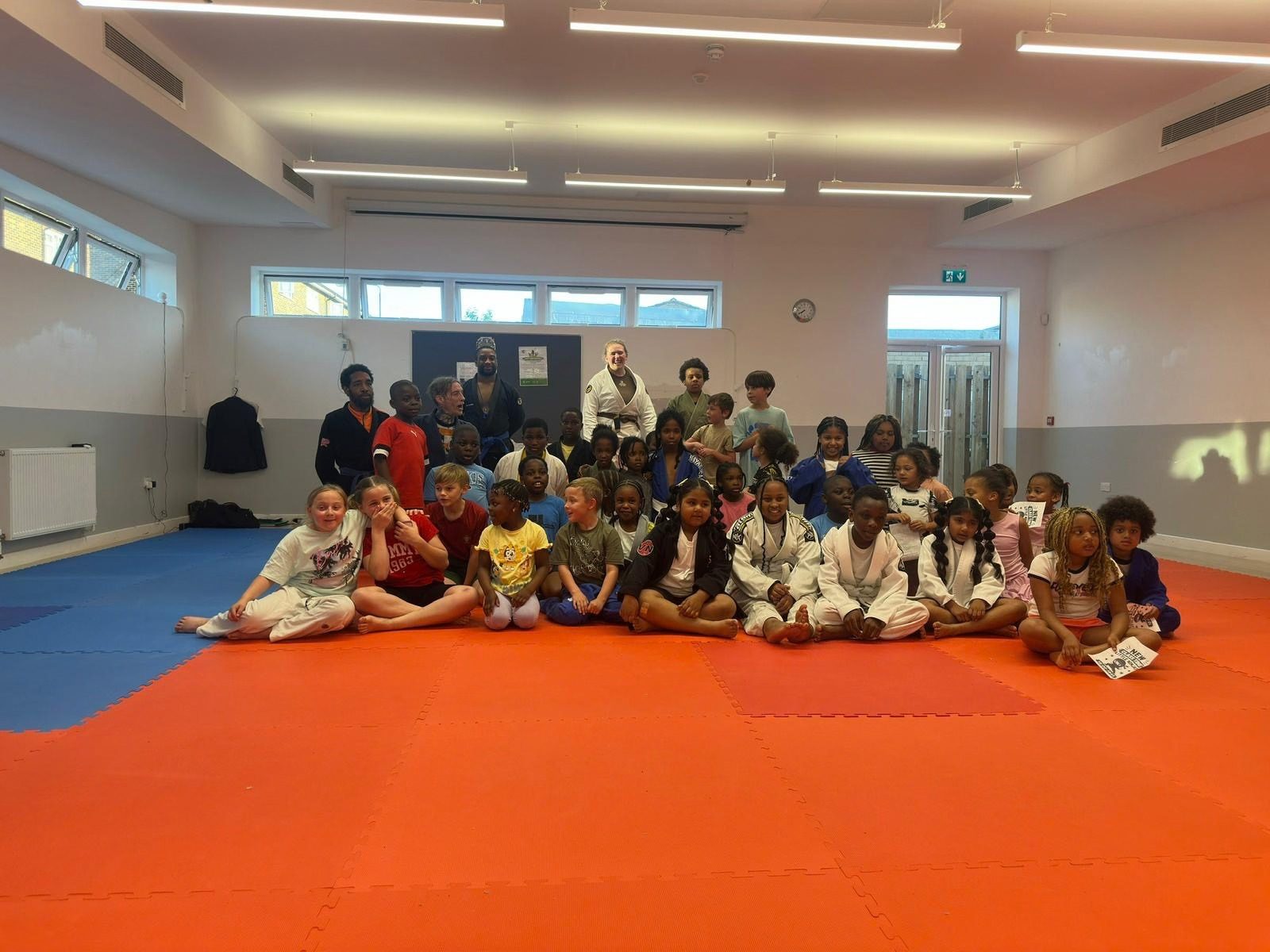Children seated on the mats