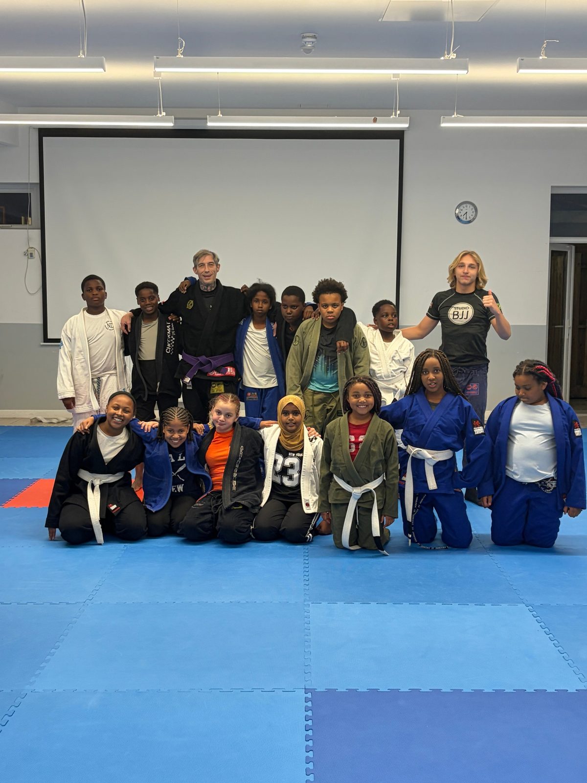 Positive Pathways Jiu-Jitsu group on the mats